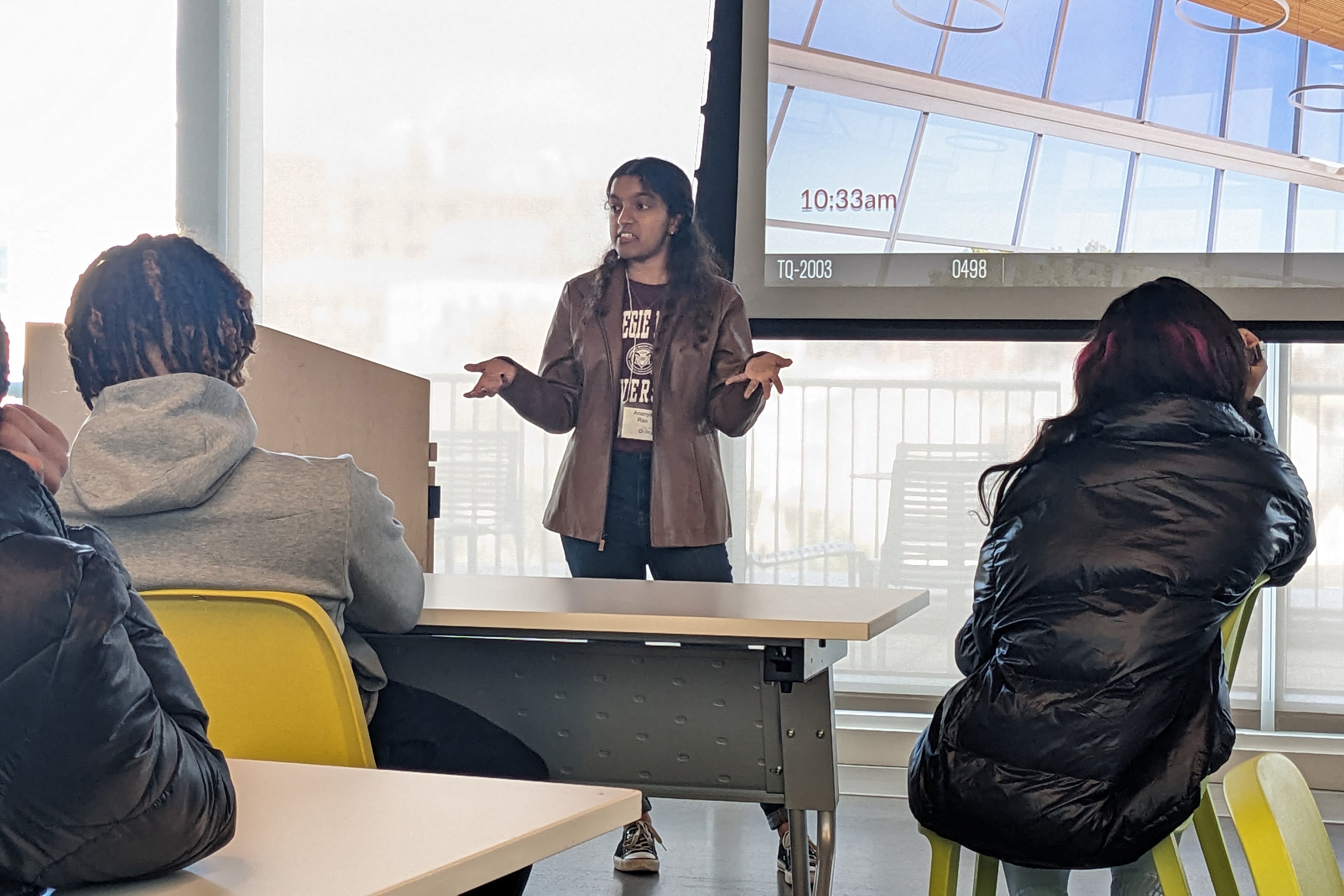 AI-SDM student participating in an outreach event by giving a lecture to high school students