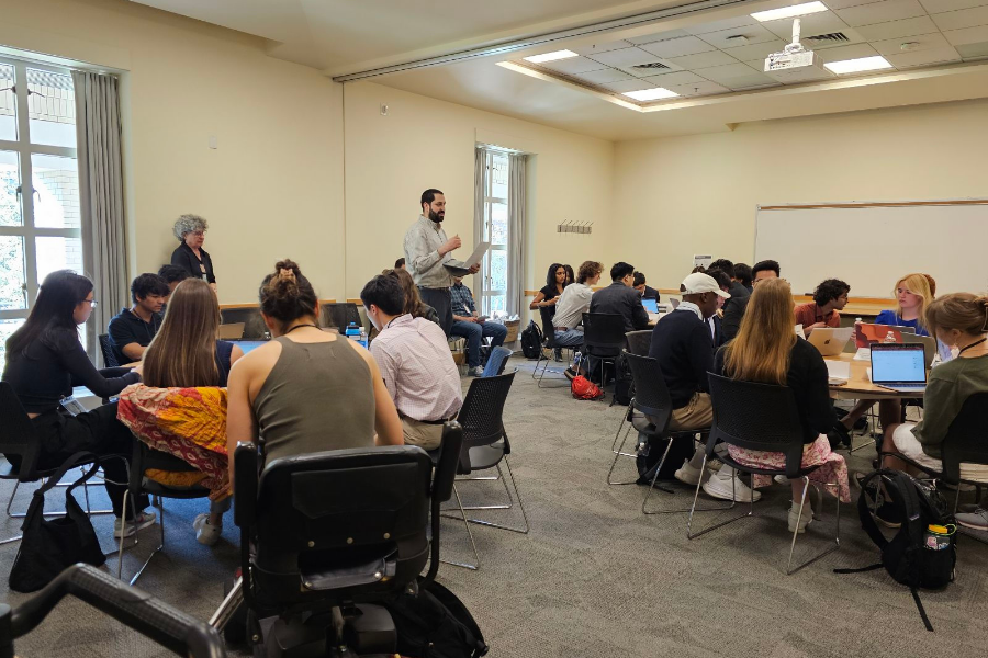Prof. Laurie Eisenberg (left) and Prof. Dan Silverman (right) assist students taking War and Peace in the Contemporary Middle East during a simulation of a regional summit