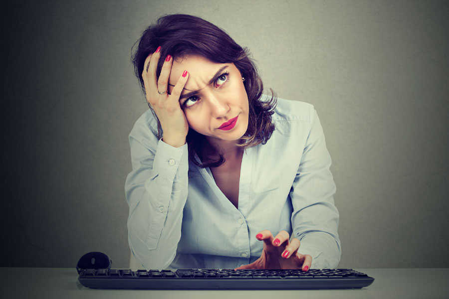 Frustrated woman trying to remember password.
