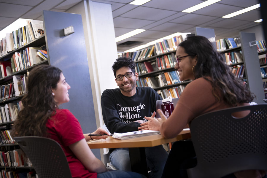 Students studying together around a table in the library.