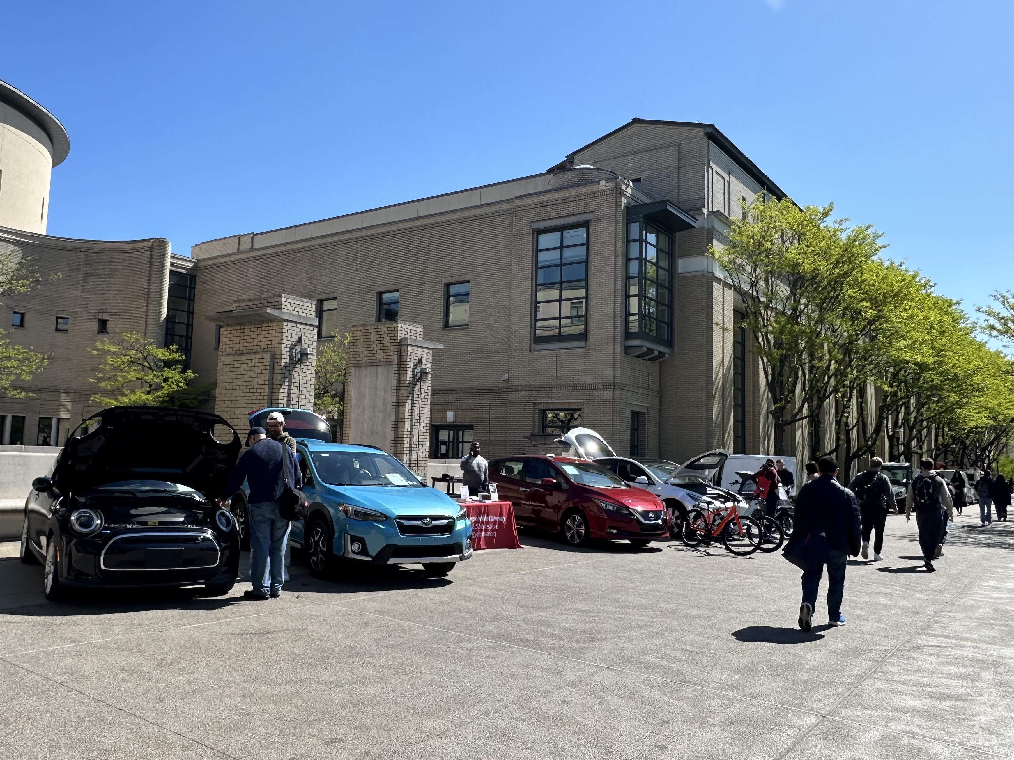 Cars Displayed on Sidewalk in front of CMU's Cohon Center with students walking by