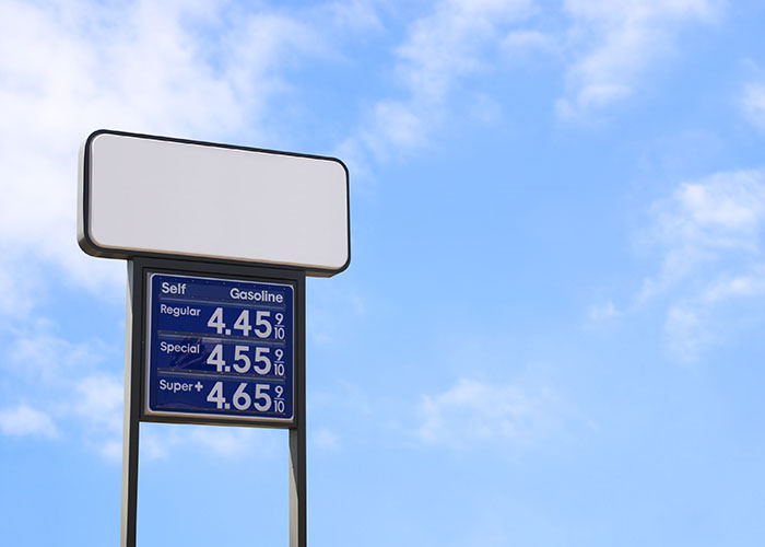 Image of a gas station sign against a blue sky backdrop
