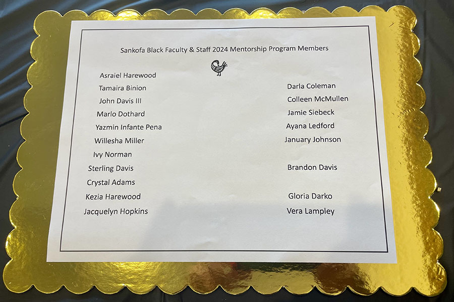 List of program participants on gold background during the Sankofa mentorship program luncheon