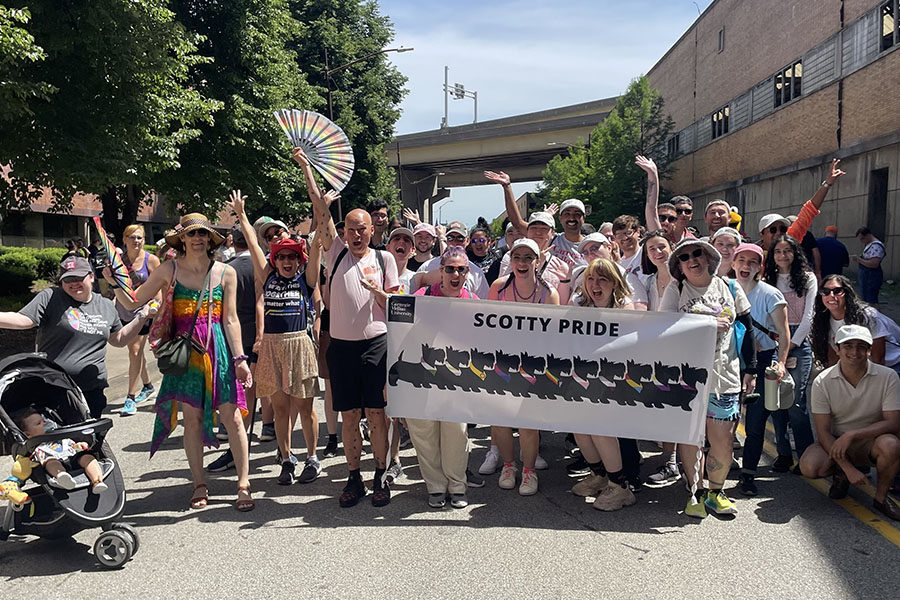 CMU participants at Pride March and Parade posing with Scotty Pride banner