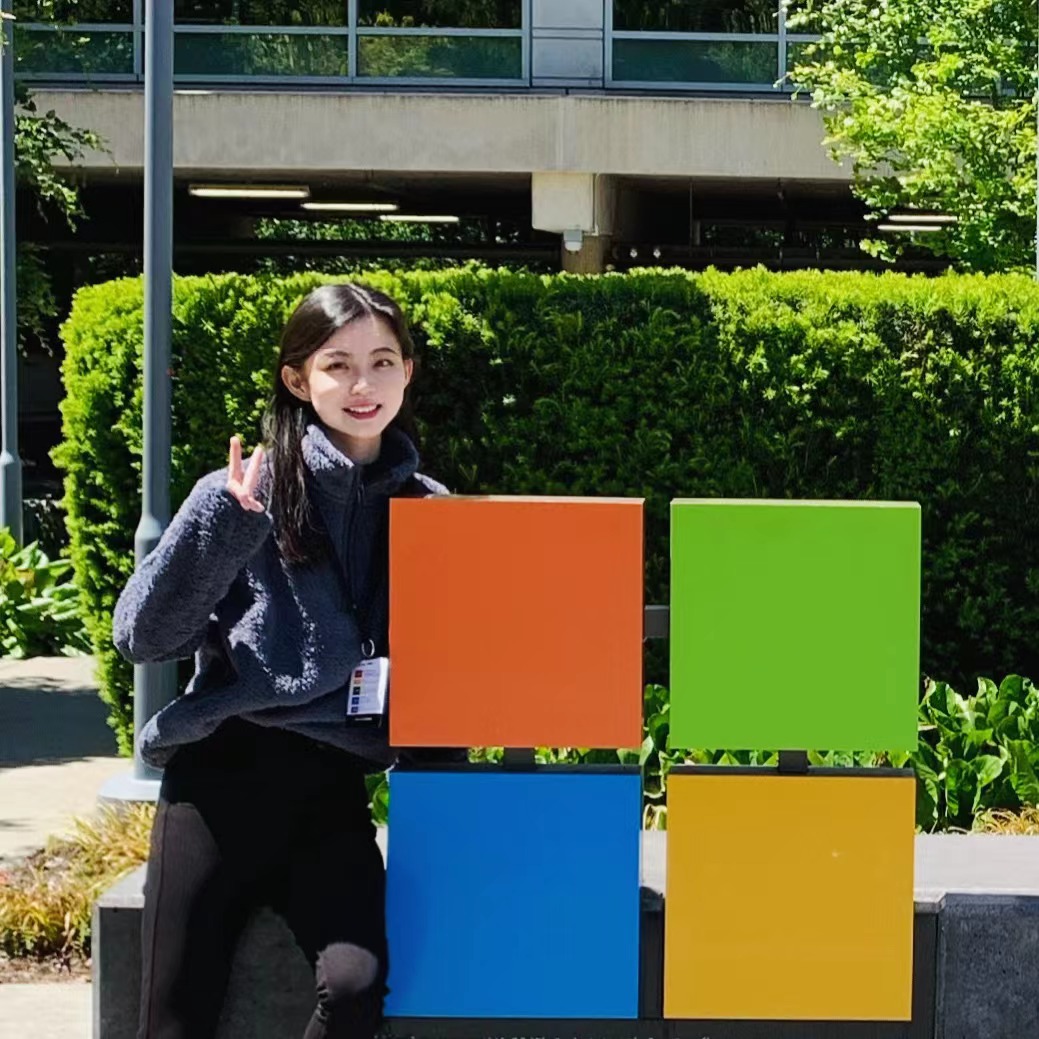 student jeni huang poses with the Microsoft sign at headquarters