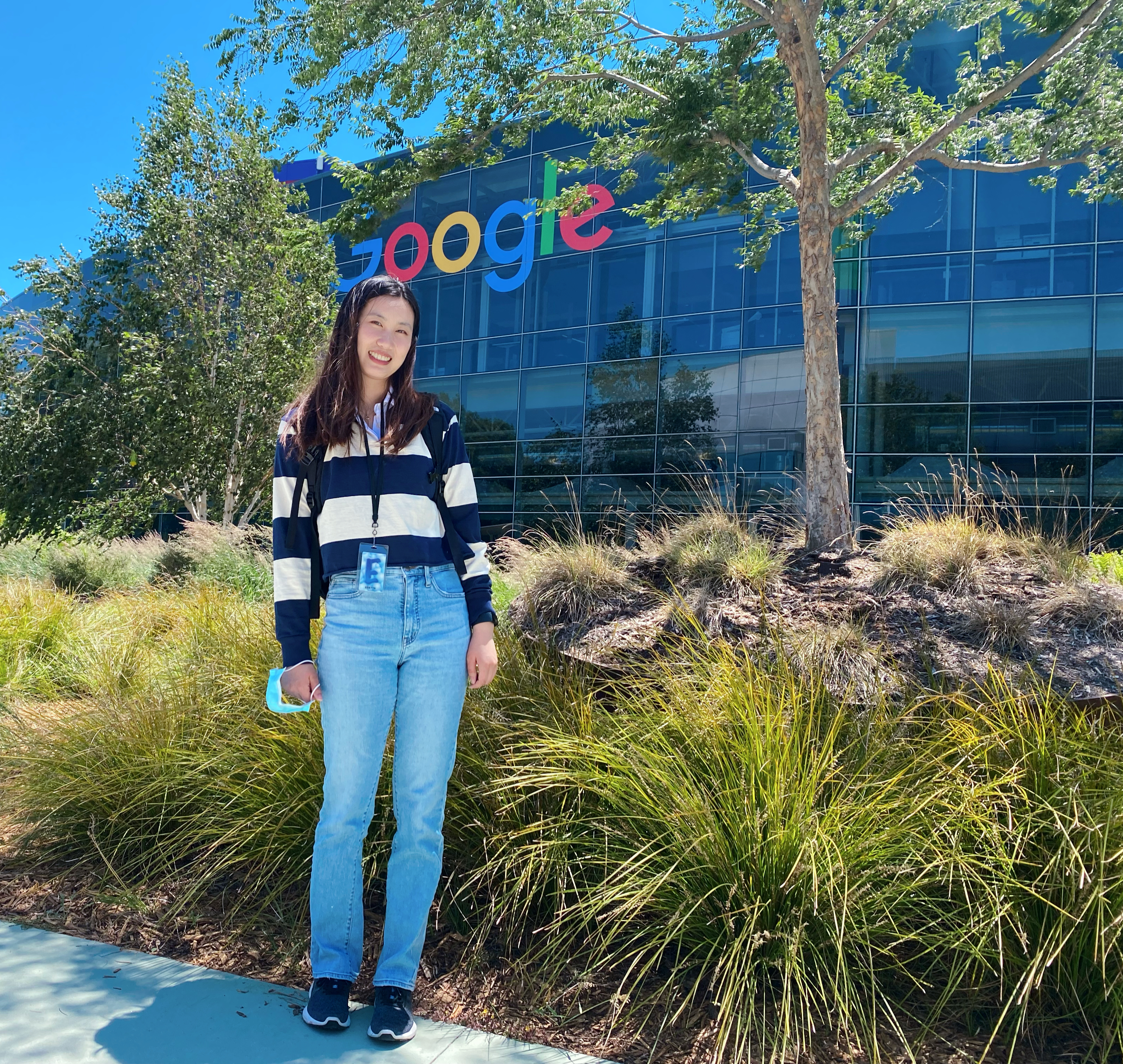 student yiyuan zhu stands in front of the Google building on the Bay Area campus