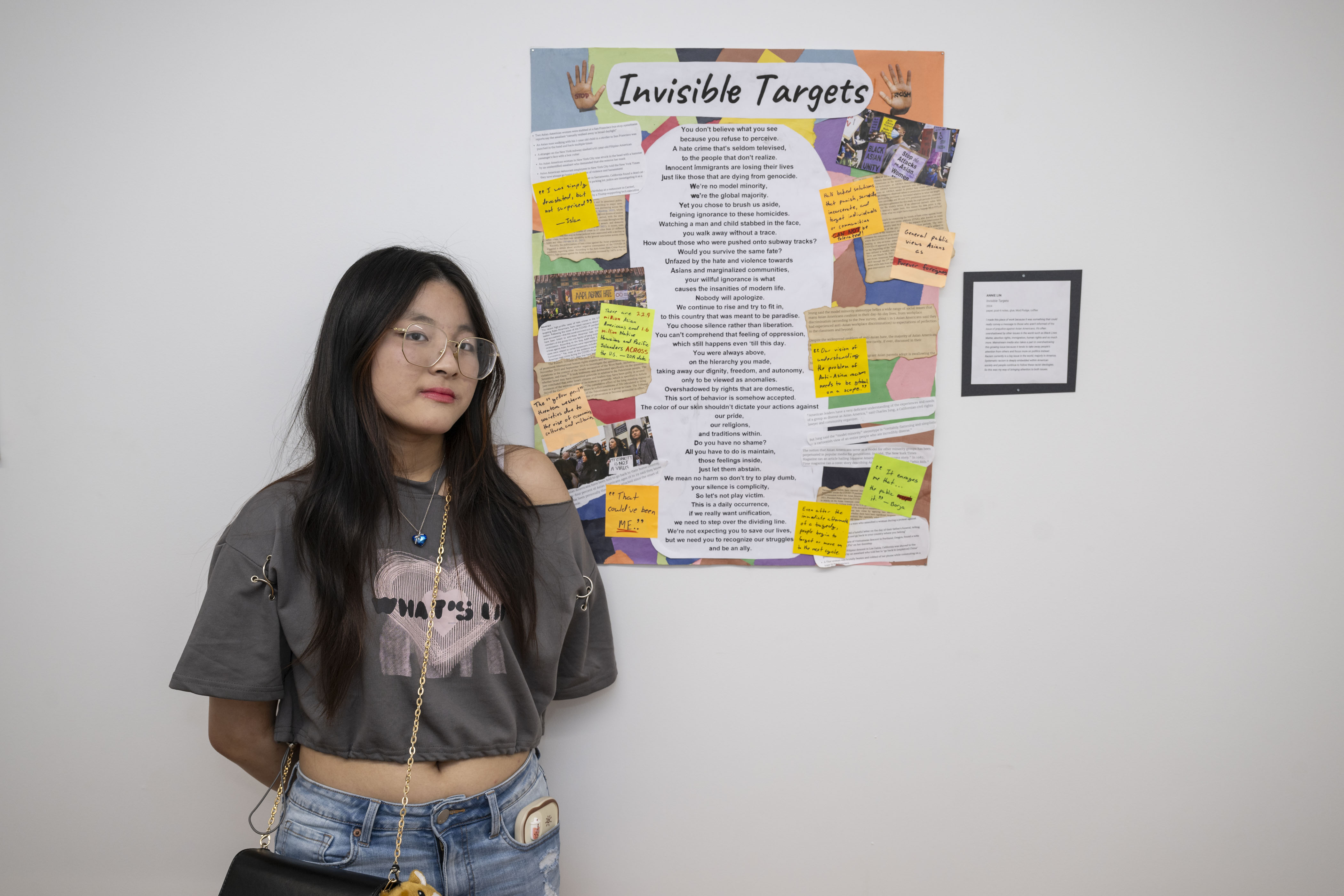 LEAP student, Annie, standing next to a poem she wrote surrounded by a collage of pictures of AAPI people protesting against Asian discrimination.