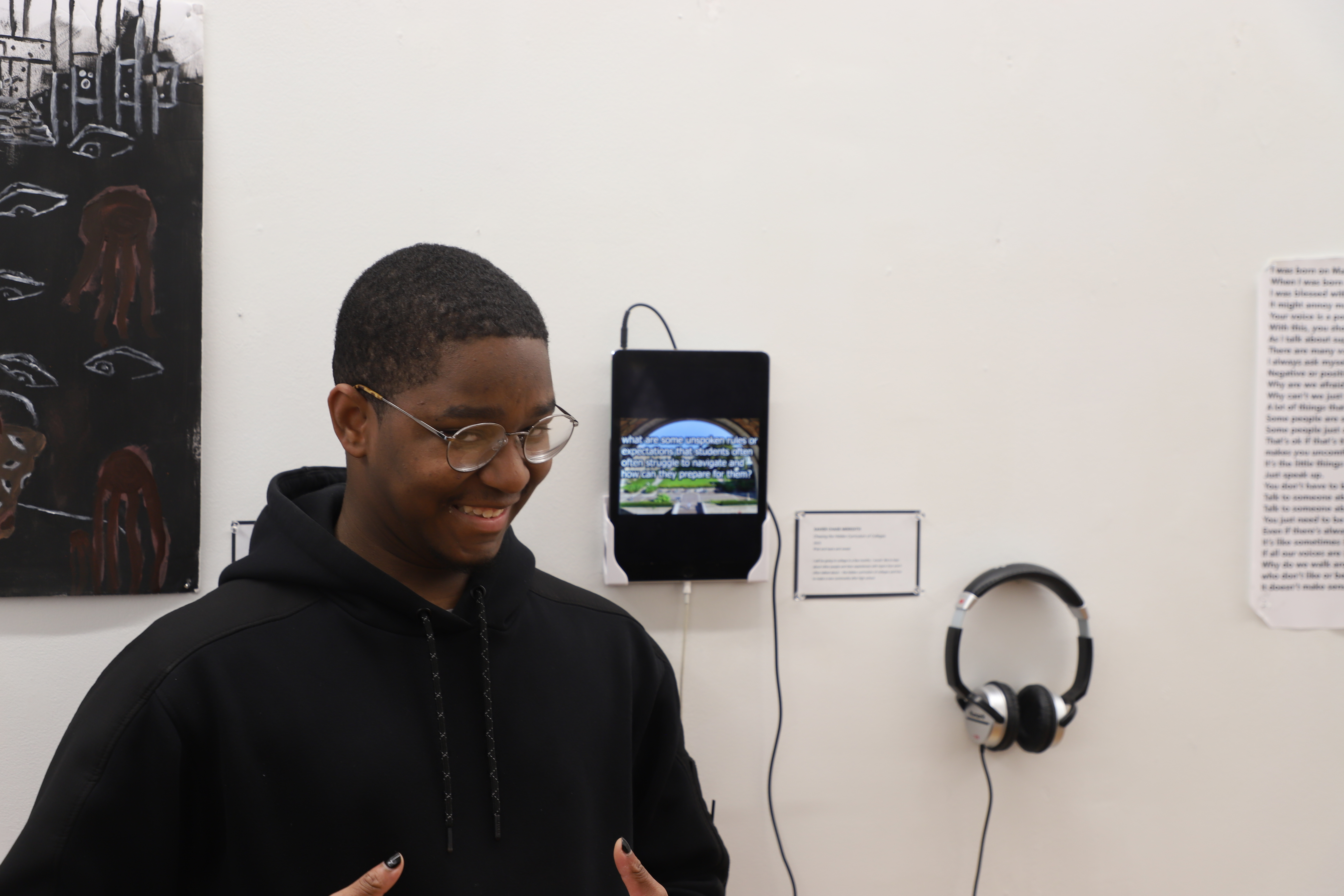 LEAP student Chase standing next to an iPad playing the audio recording of interviews he created