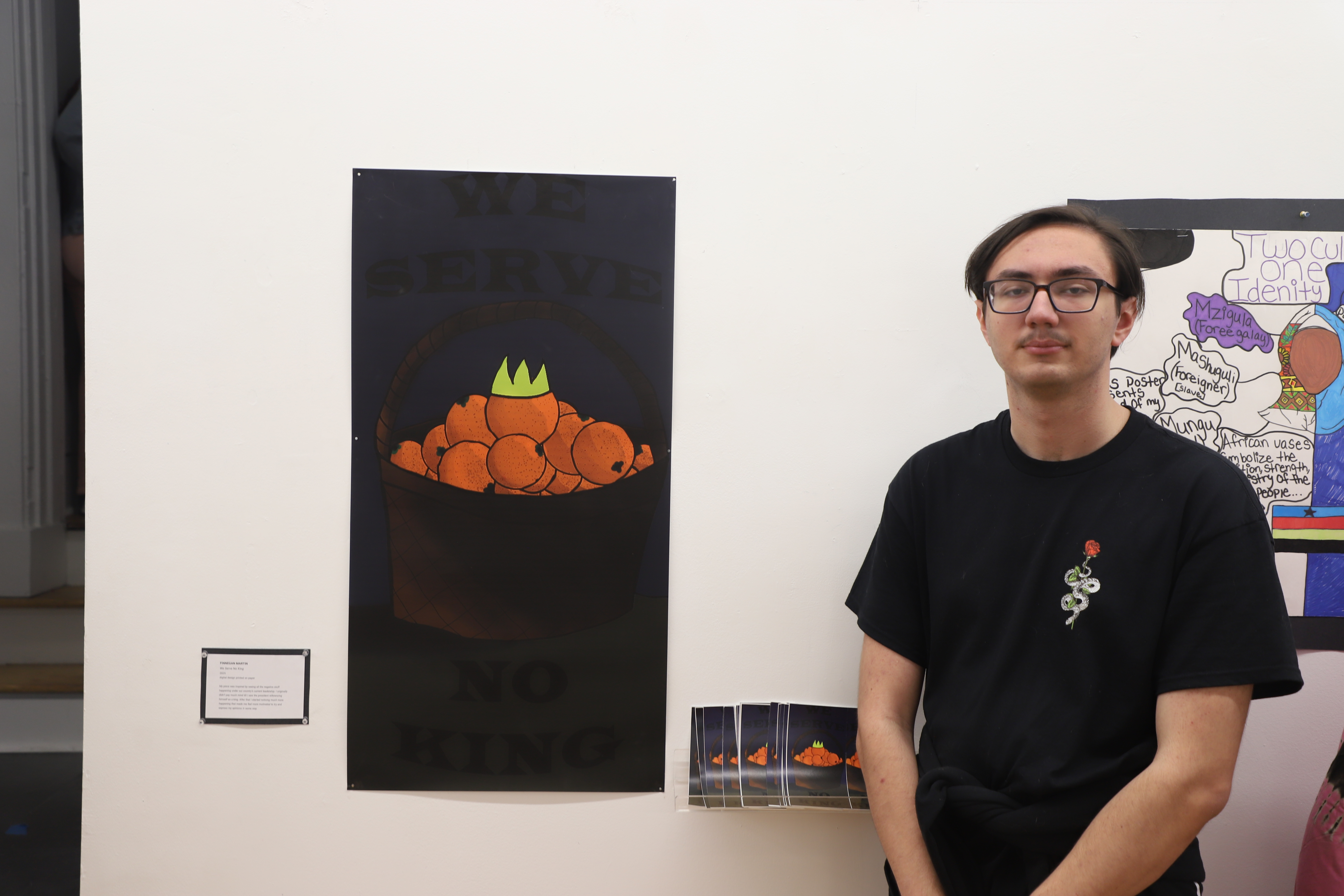 LEAP student Finn standing next to the poster he created