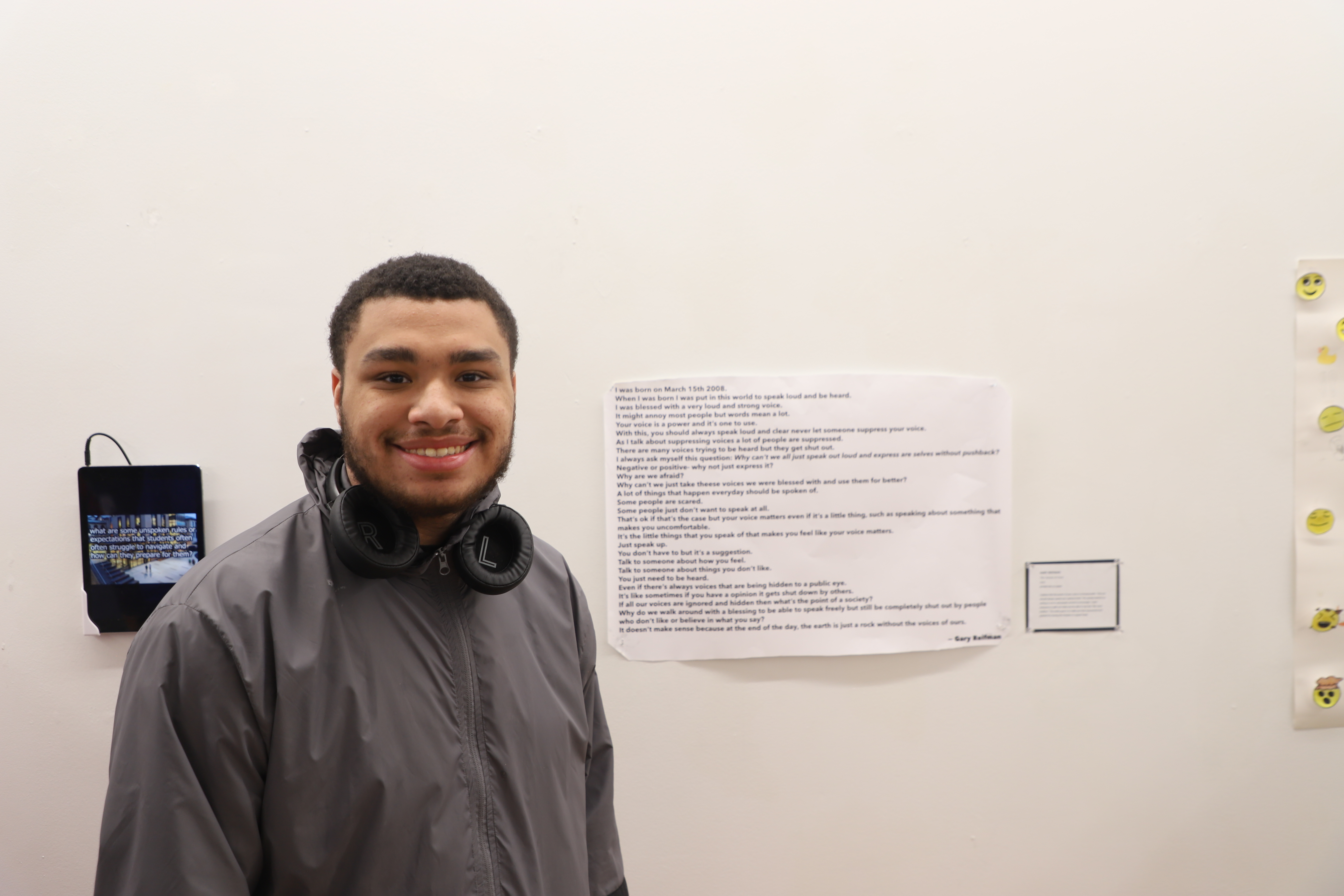 LEAP student Gary standing next to a piece of writing he created