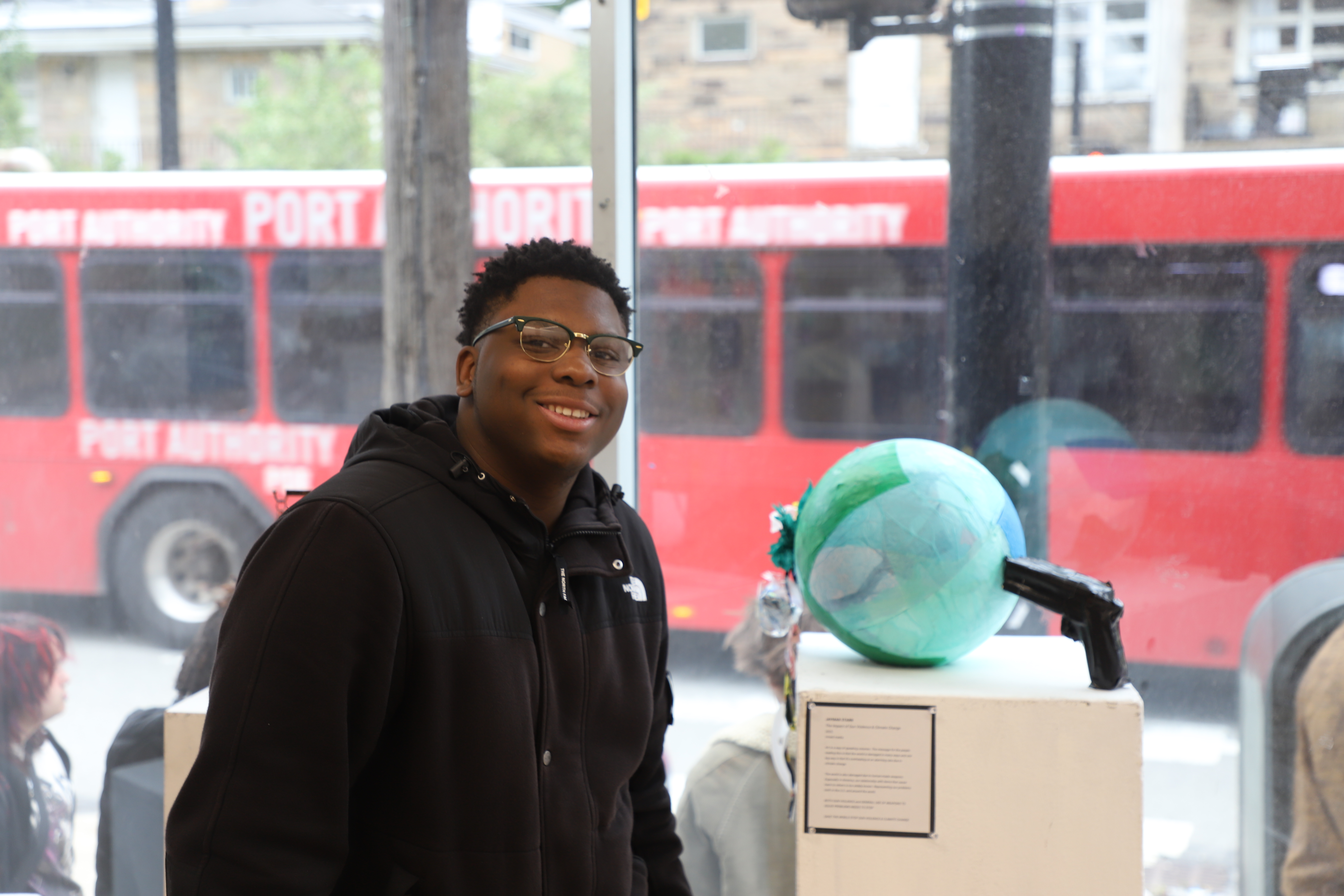 LEAP student Jaymar standing next to a sculpture he made