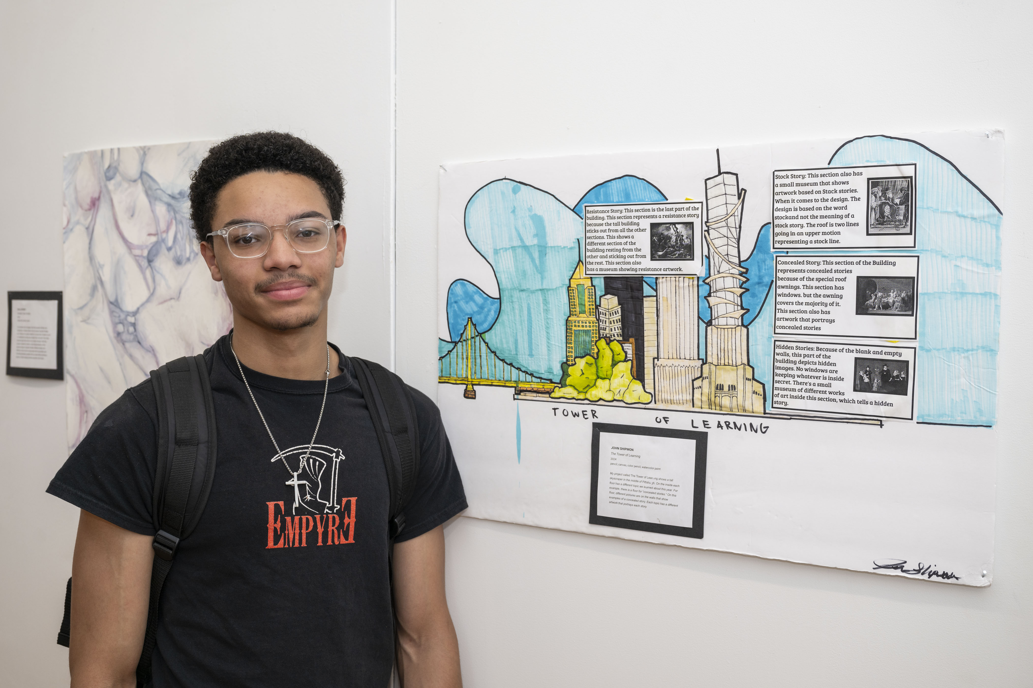 LEAP student, John, standing next to a drawing he created
