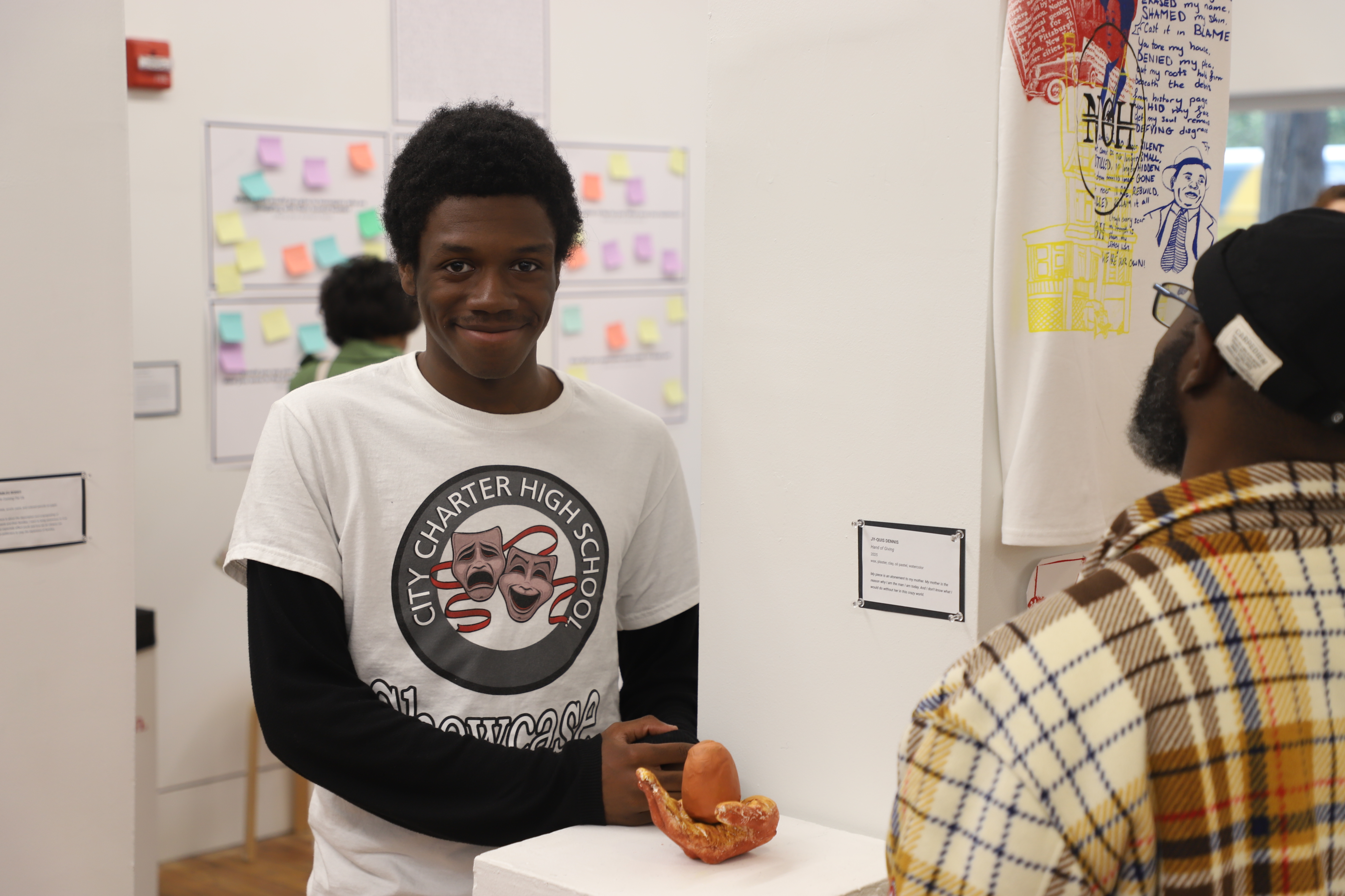 LEAP student Jy-Quis standing next to a sculpture he made