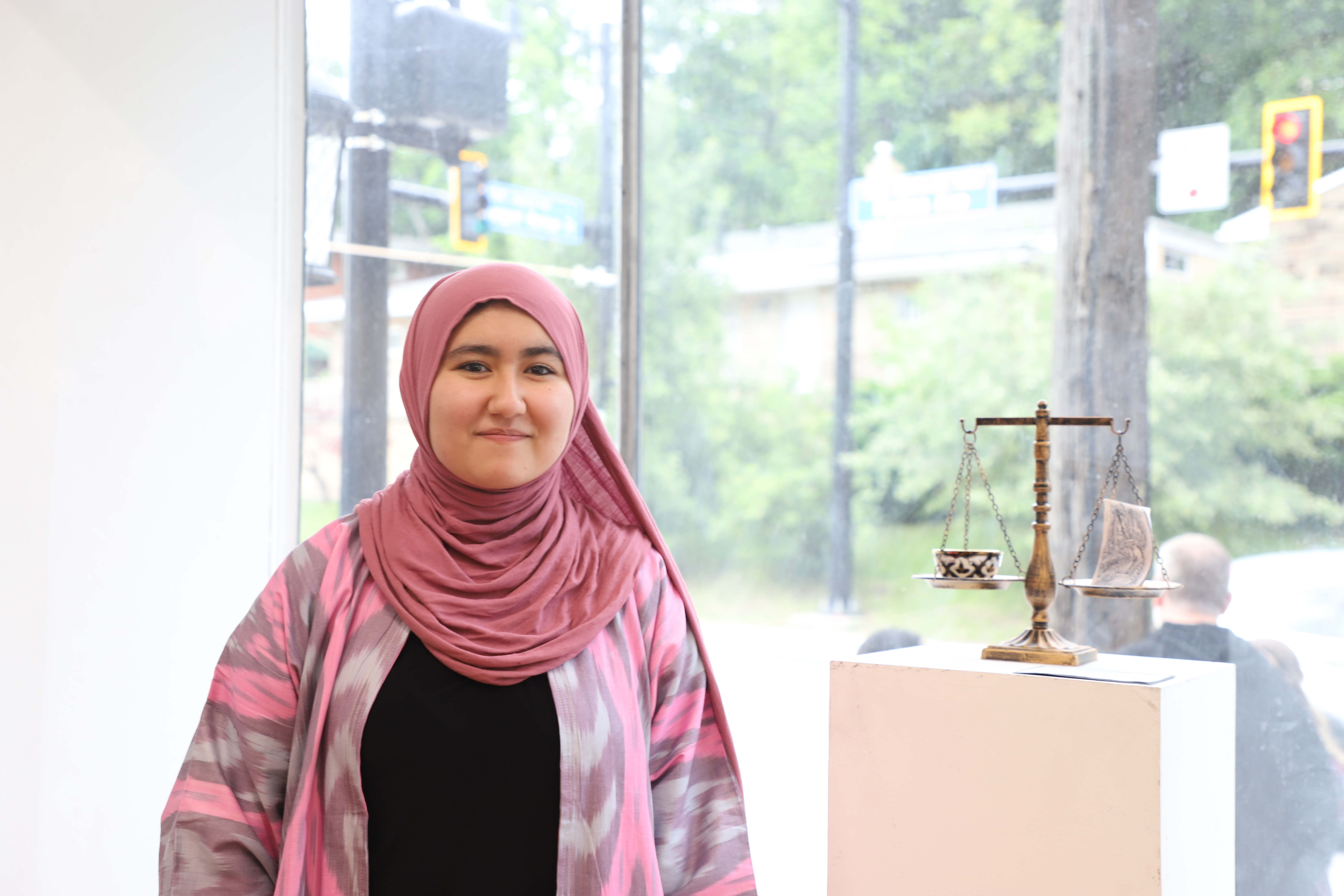 LEAP student Husniya standing next to a sculpture she made