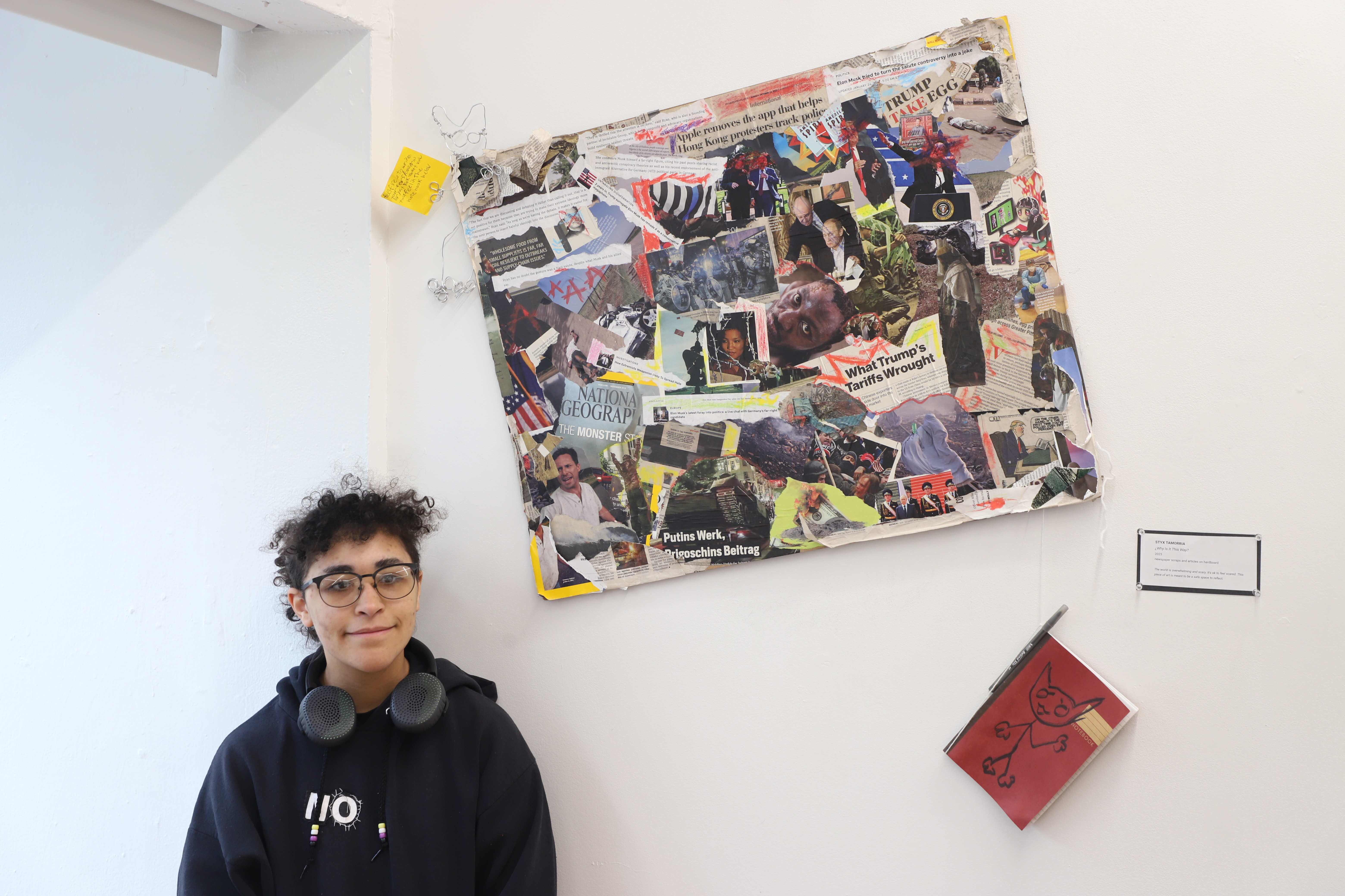 LEAP student Styx standing next to a collage they made