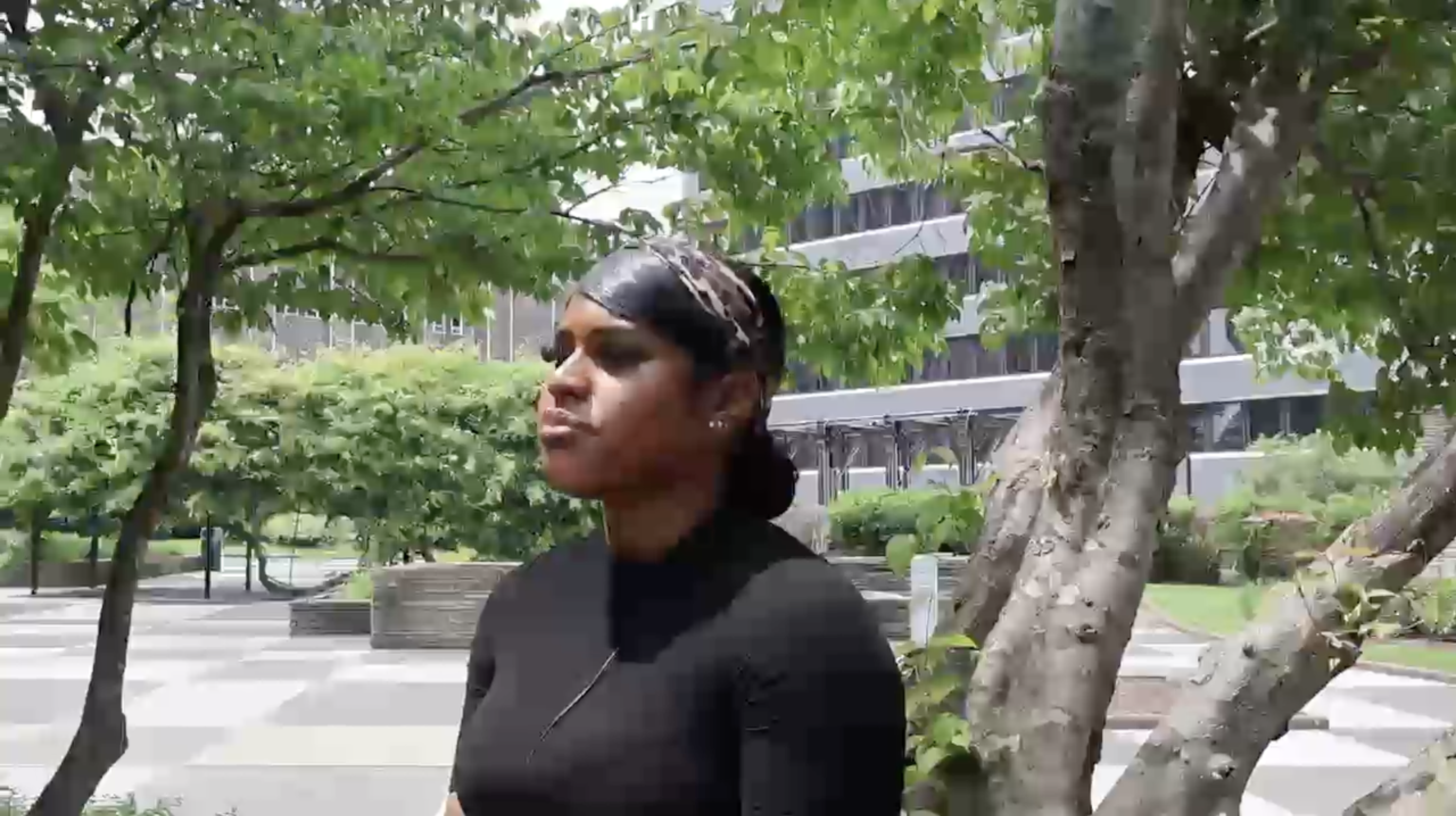 Still image from a video where LEAP student, Tai'Joura, recites a spoken word poem outside.