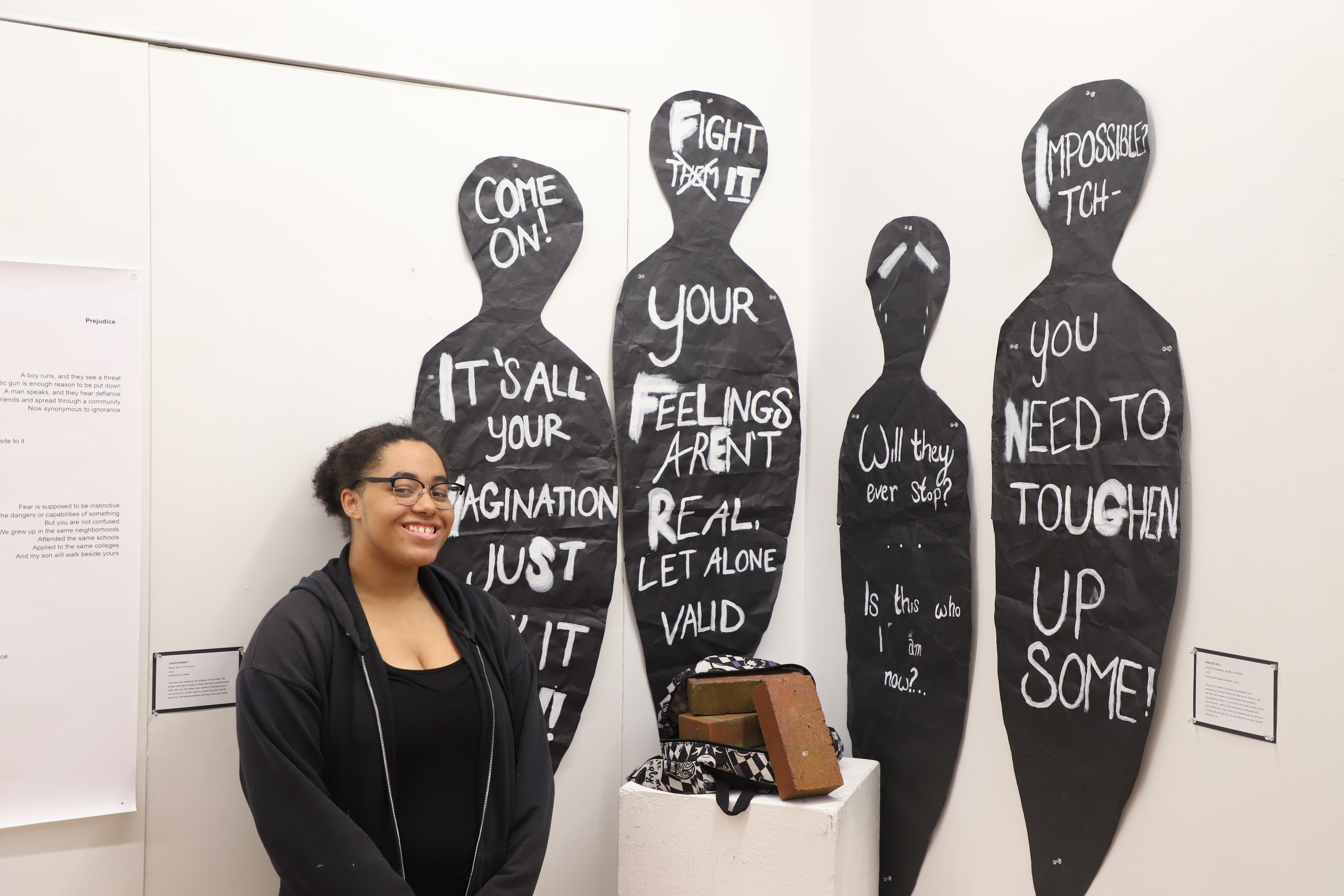 LEAP student Xhileze standing next to an installation she created