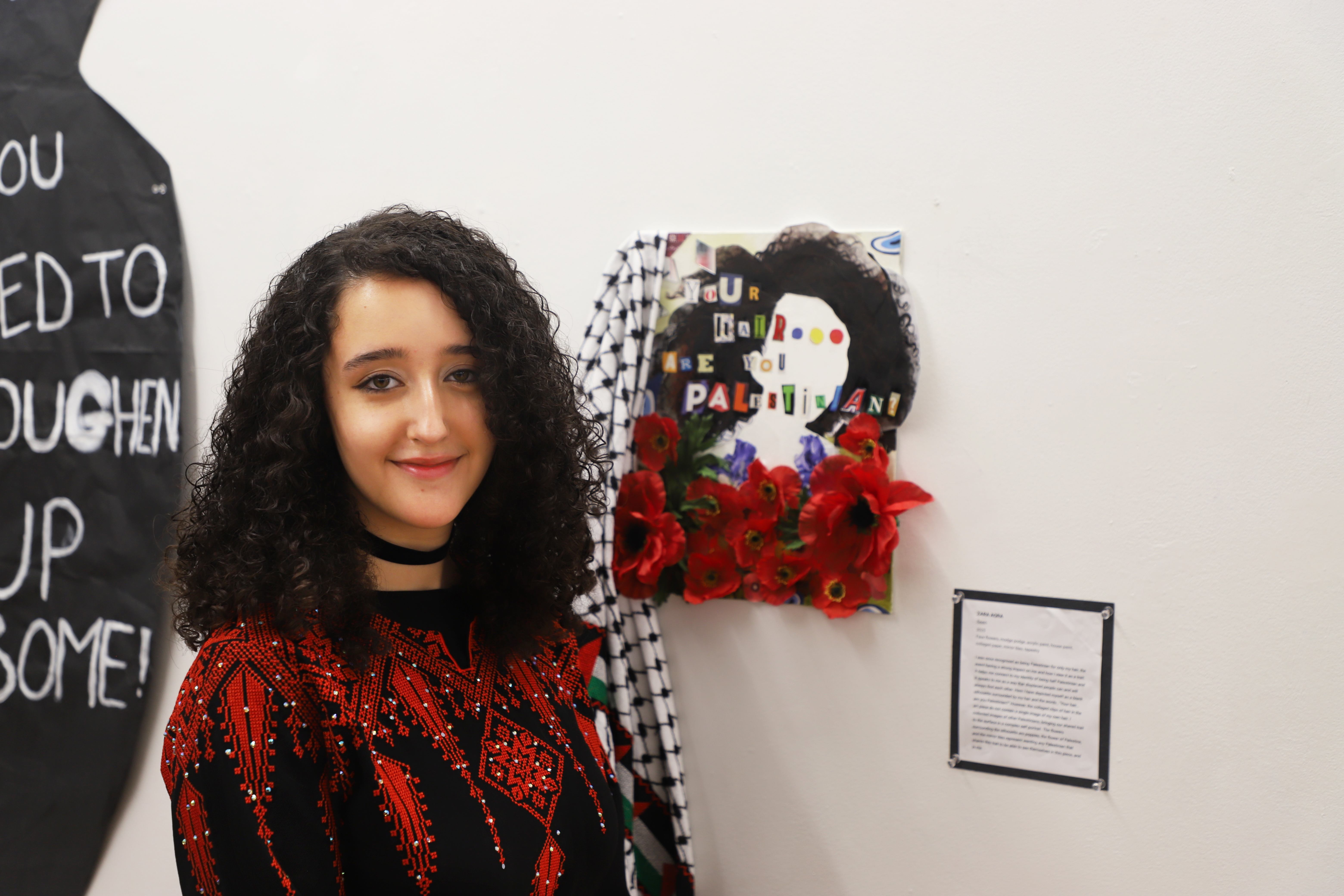 LEAP student Zara standing next to a collage she made