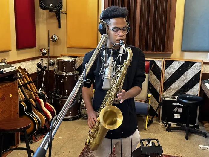 Eric Parker playing sax in a recording studio