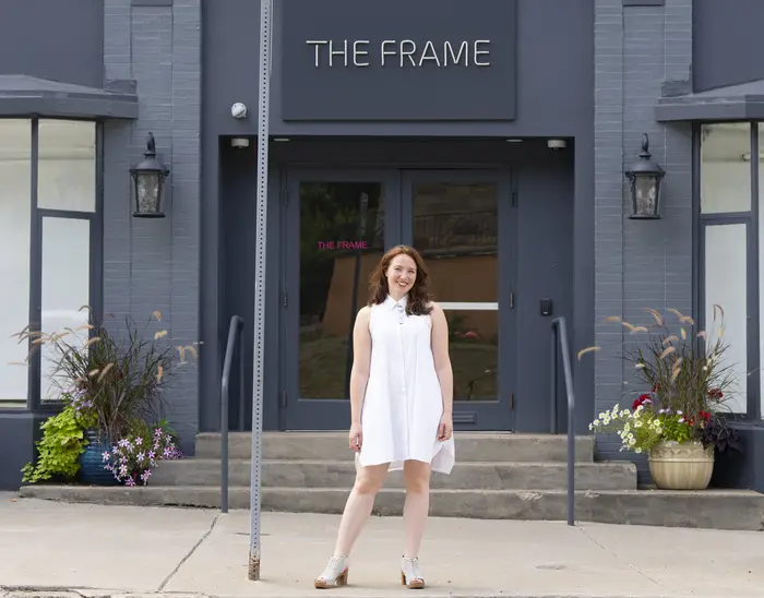 Sarah Ceurvorst standing in front of The Frame gallery