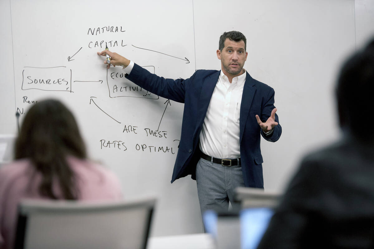 Nick Muller teaching at a white board with students in foreground
