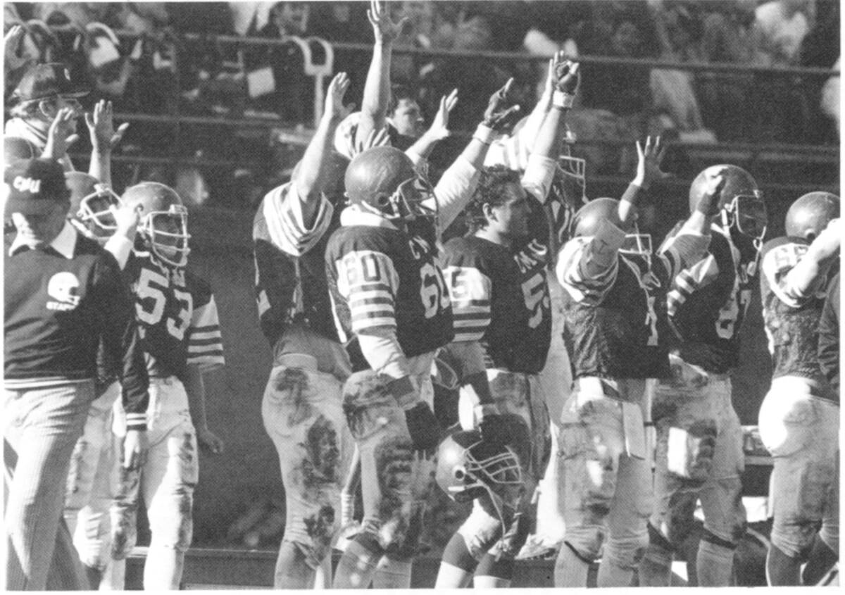 The 1983 football team cheering