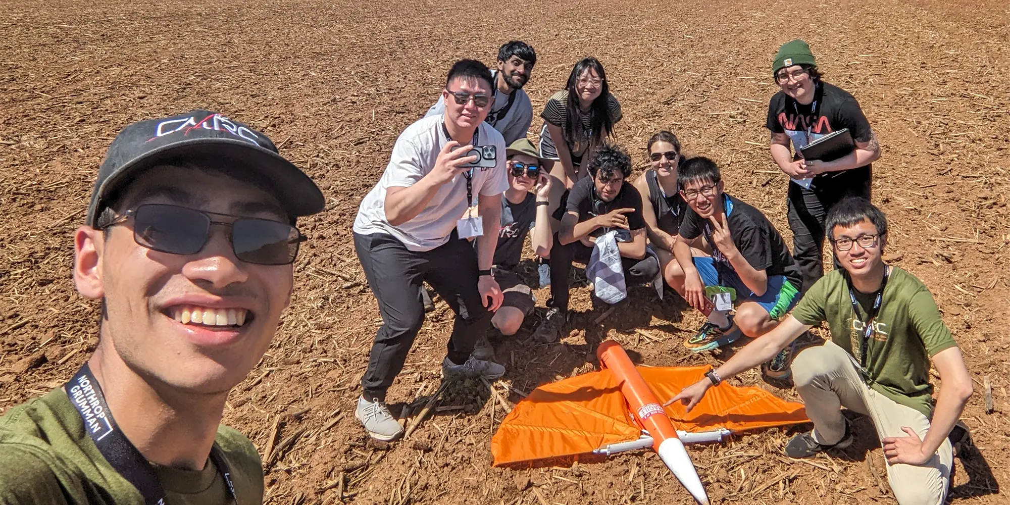 students taking selfie with rocket