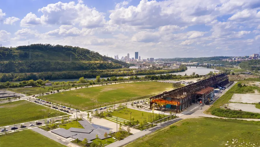 aerial view of Mill 19 in foreground with Pittsburgh, hills and sky in background