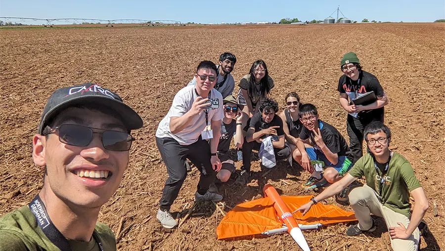 students take selfie with rocket