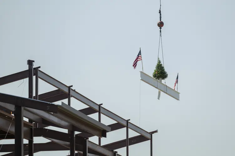 The final beam is hoisted to the top of the Robotics Innovation Center.