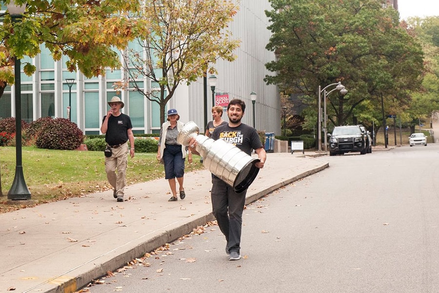 Image of Sam Ventura carrying the Stanley Cup