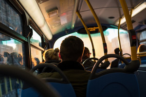 Image of the back of passengers' heads inside a bus