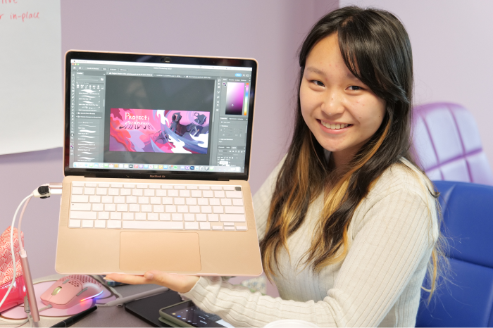 Pre-College National High School Game Academy student showing work on laptop. 