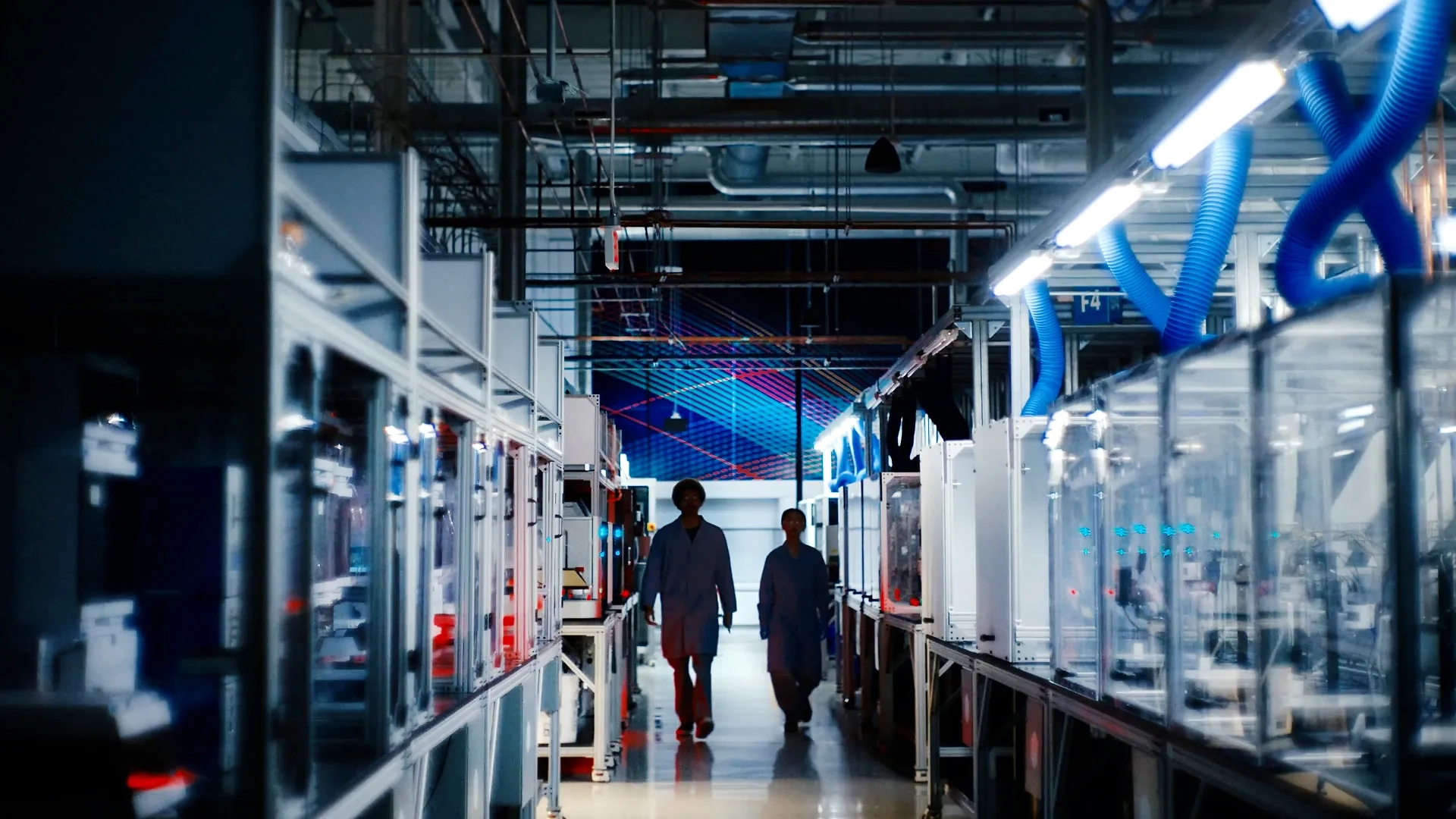 Two people walking in an automated lab