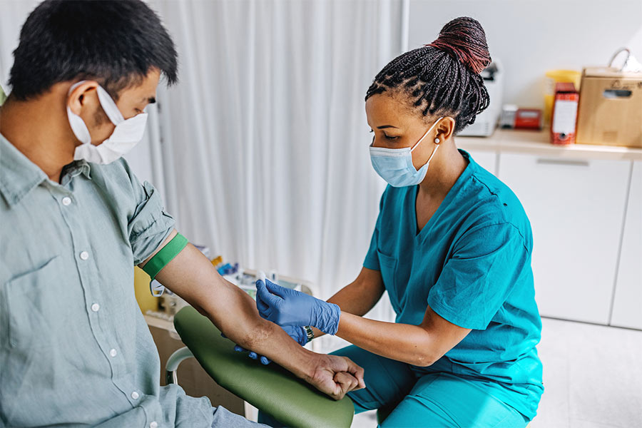 Nurse drawing blood from patient
