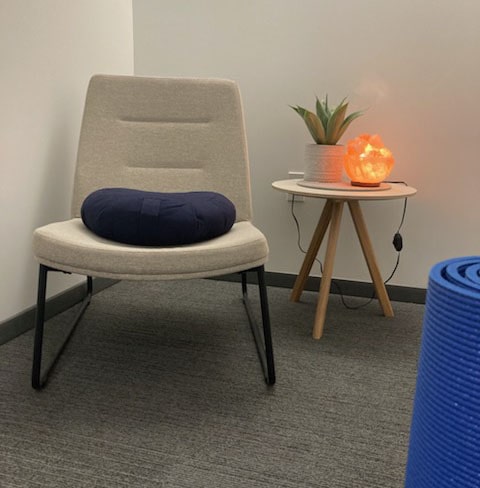 a chair, table, lamp and yoga mat